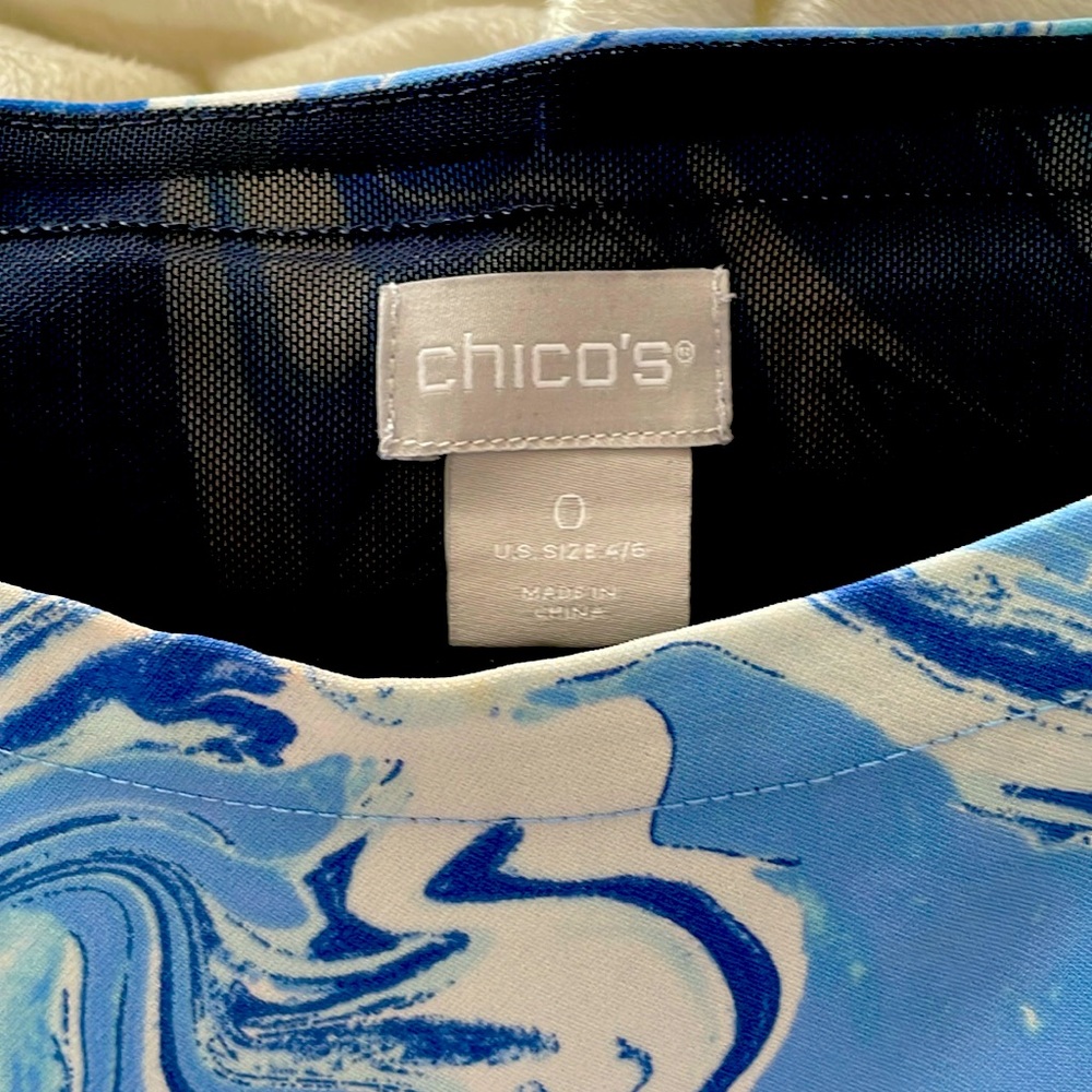 Blue abstract design looks kind of like ocean waves, shark bite style hem.
